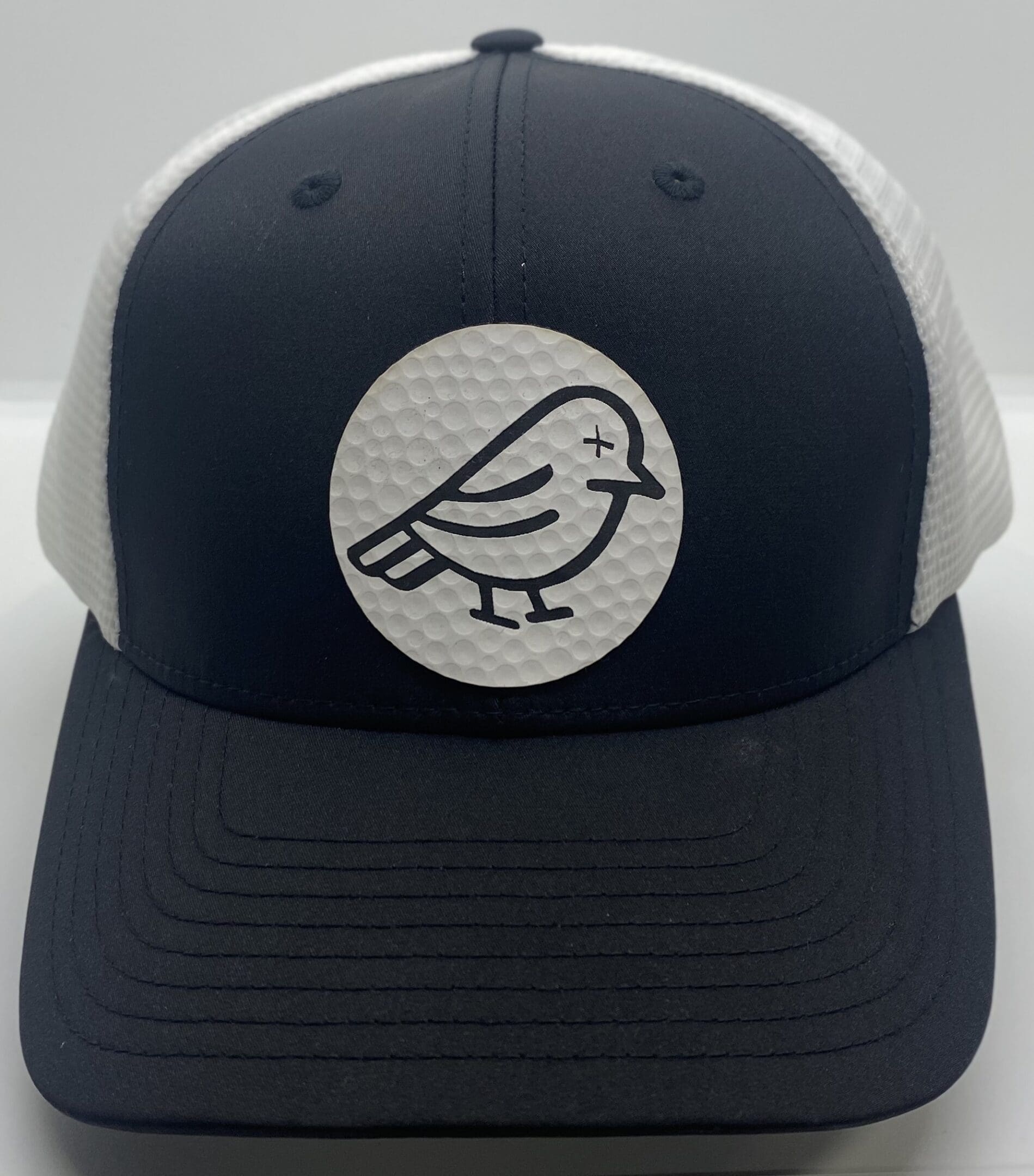 A black and white hat with a bird on it