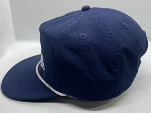 A blue hat with white string around the brim.