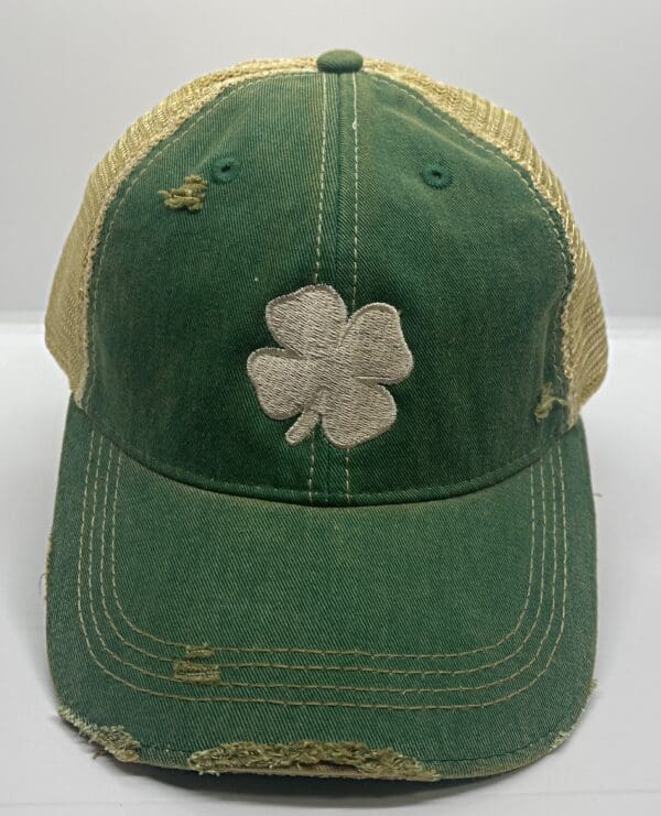 A green hat with a white clover on it.