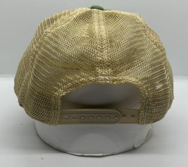 A tan hat with a green and white logo on it.