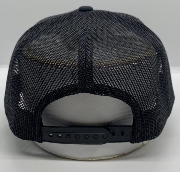 A black hat with a mesh back and a black strap.