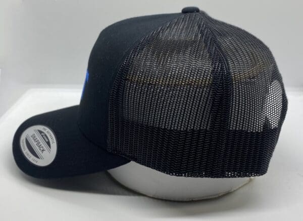 A black hat with a white and blue logo on it