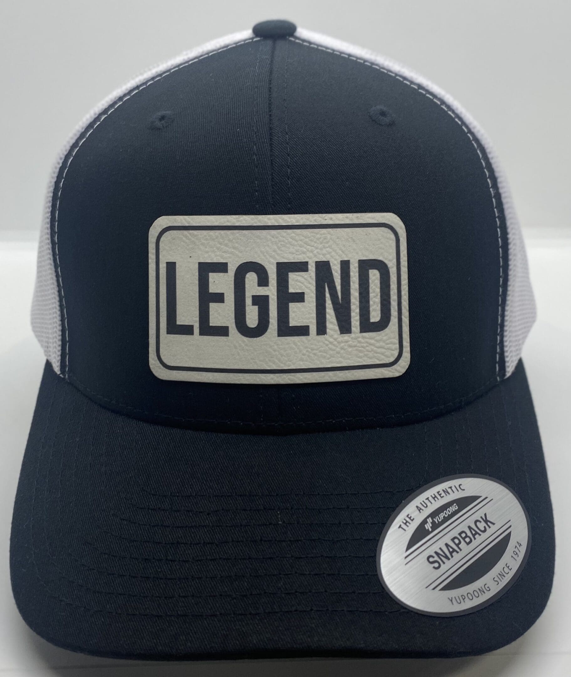 A black and white legend hat with a patch on it.