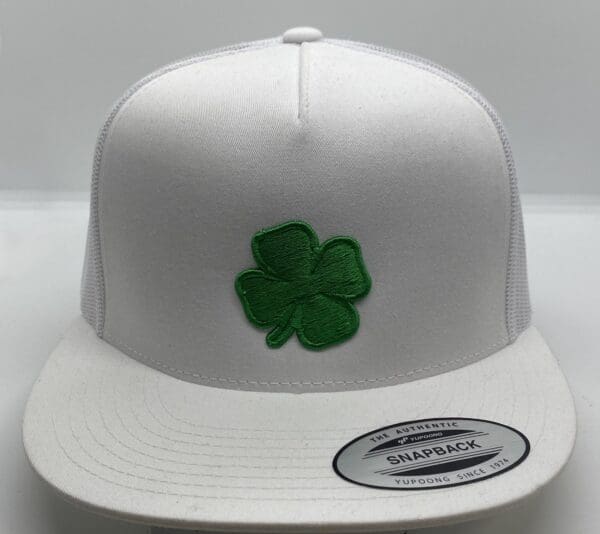 A white hat with a green clover on it.