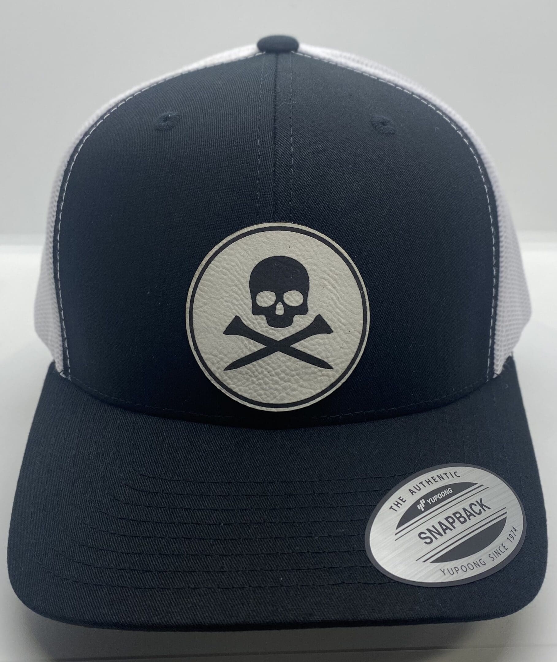 A black and white hat with a skull on it