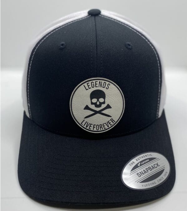 A black and white hat with a skull patch on it