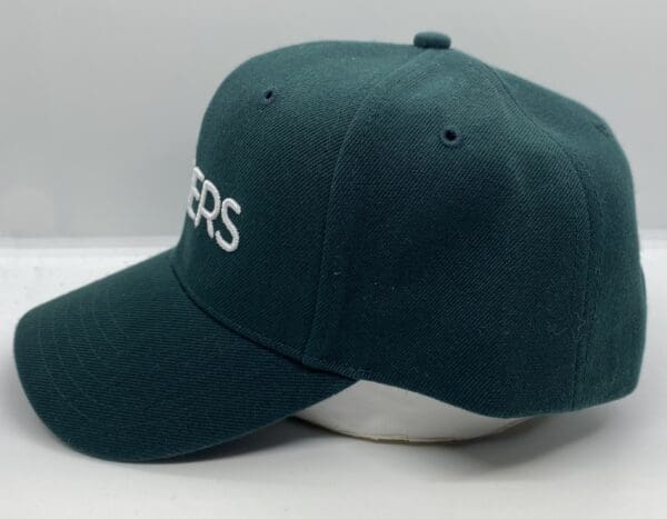 Dark green cap with white lettering.