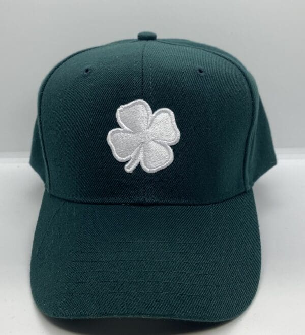 Green cap with white clover emblem.