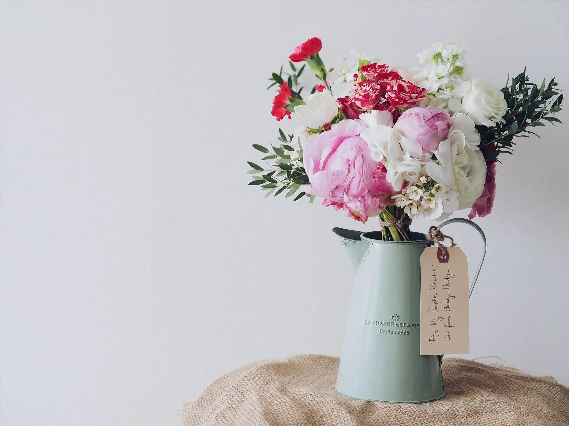 Colorful bouquet in vintage pitcher vase.